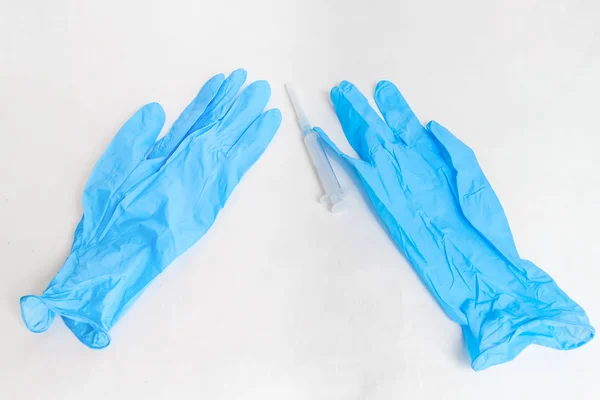 Syringe and blue gloves — Stock Photo, Image