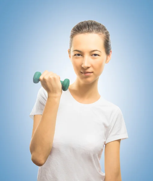 Woman smiles with a dumbbell — Stock Photo, Image