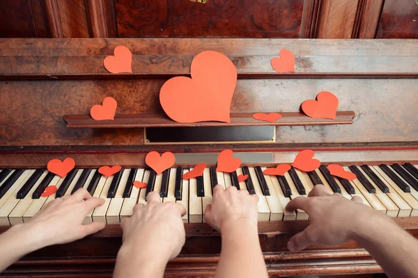 Couple is playing on piano on Valentine's Day — Stock Photo, Image