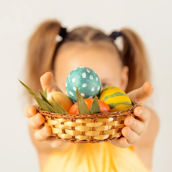 Girl gives basket with Easter eggs — Stock Photo, Image