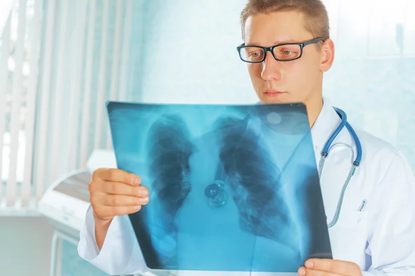 Médico olha para a imagem de raio-x — Fotografia de Stock