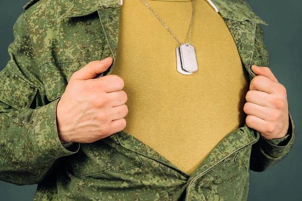 Military man opens his shirt, copyspace — Stock Photo, Image