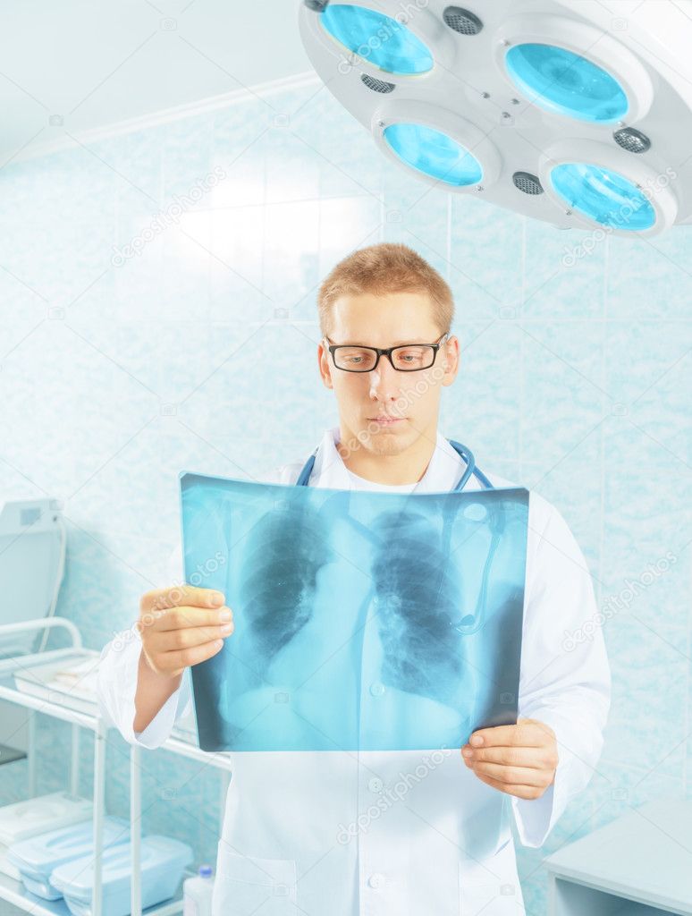 Physician examines x-ray picture