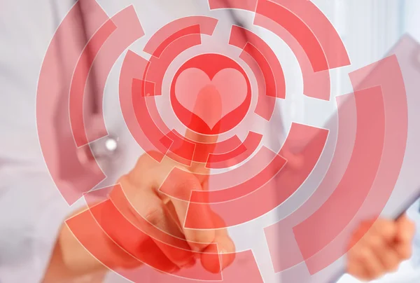 Doctor is touching shape of red heart — Stock Photo, Image