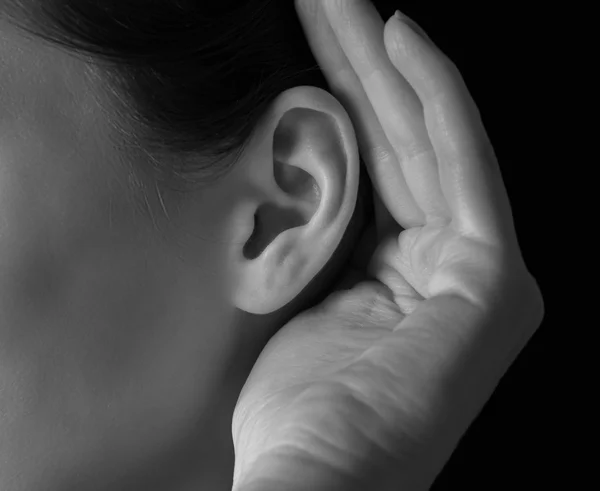 Woman holds her hand near ear — Stock Photo, Image