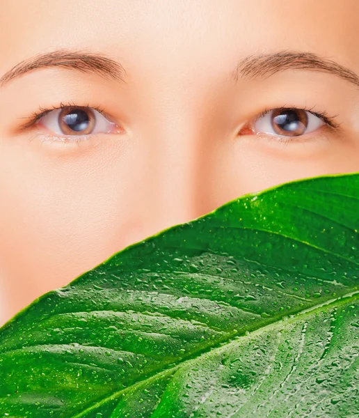 Vacker kvinna och gröna blad — Stockfoto