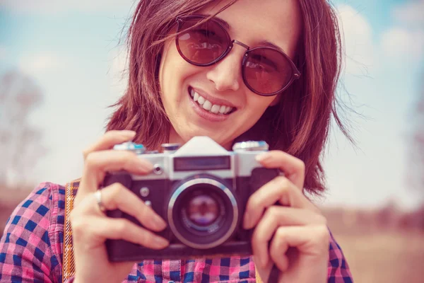 Woman holds old photo camera — Stock Photo, Image