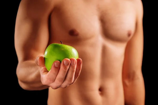 Strong man holds apple