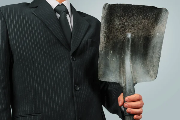 Businessman with shovel — Stock Photo, Image