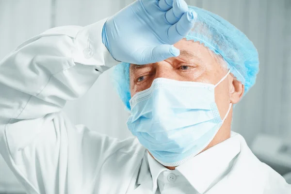 Tired senior man surgeon — Stock Photo, Image