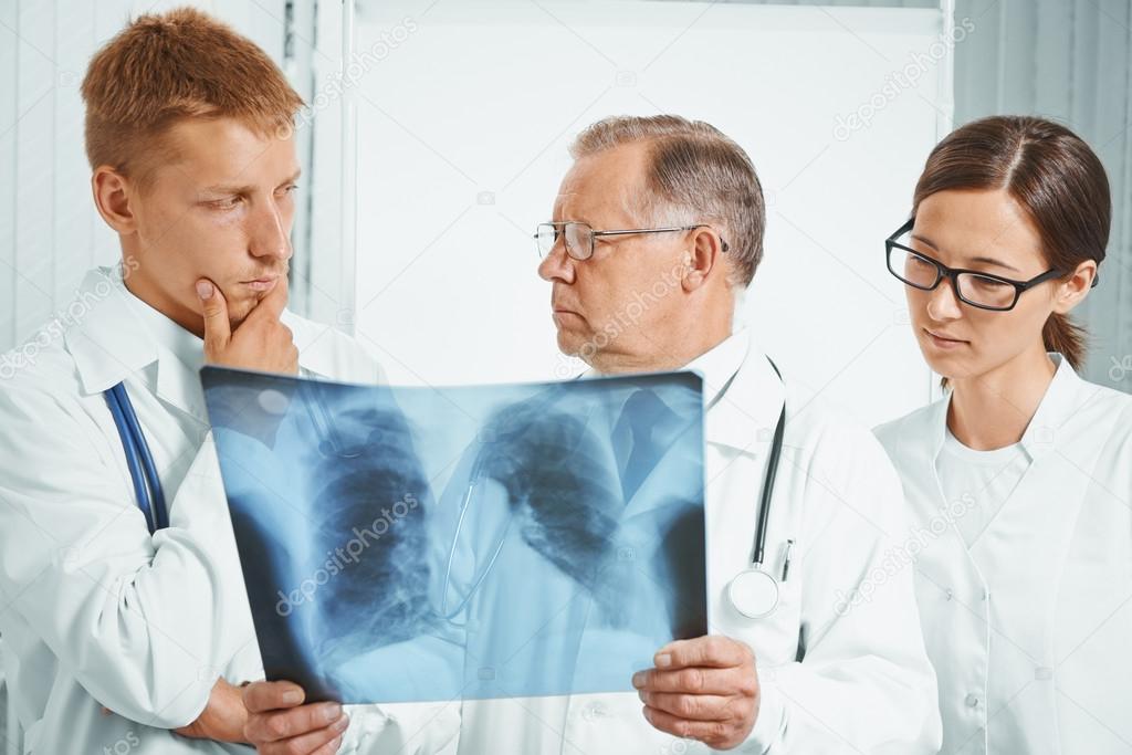 Doctors examine x-ray image in hospital