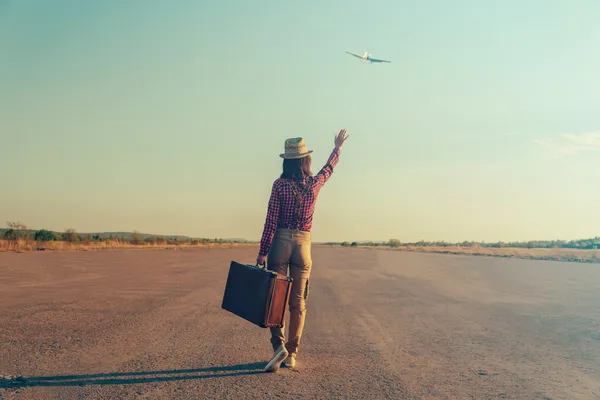 Mujer viajera agita su mano al avión —  Fotos de Stock