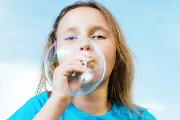 Girl blowing soap bubble — Stock Photo, Image
