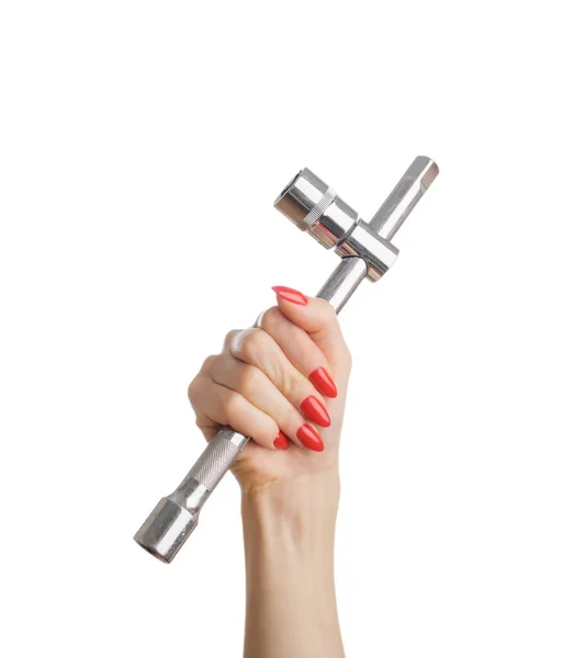 Vrouwelijke hand met moersleutel in de hand. — Stockfoto