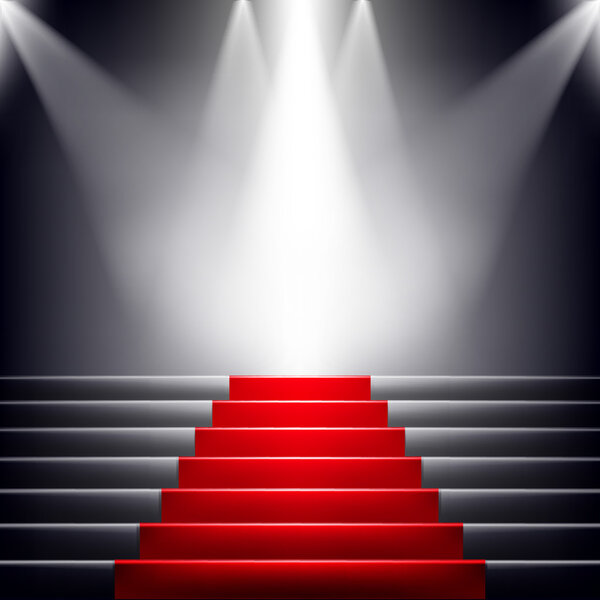 Лестница покрыта красной ковровой дорожкой. Сцена, освещенная прожектором
