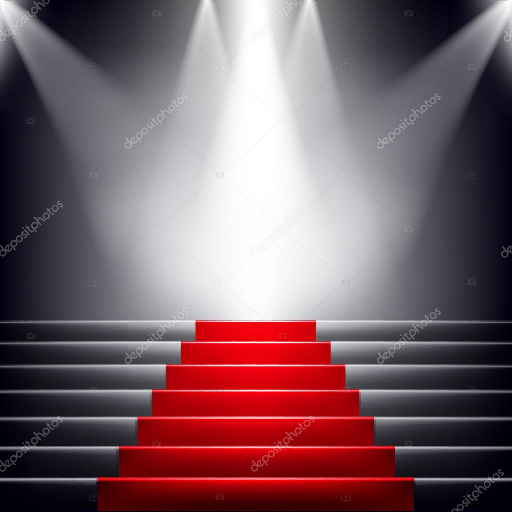 Stairs covered with red carpet. Scene illuminated by a spotlight