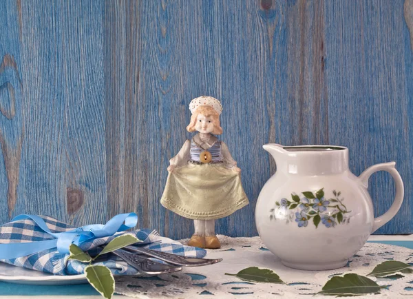 Small jug and antique doll — Stock Photo, Image