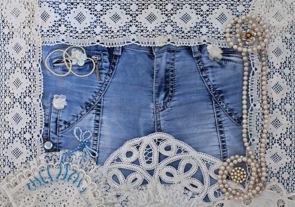 Denim background with lace and women's jewelry