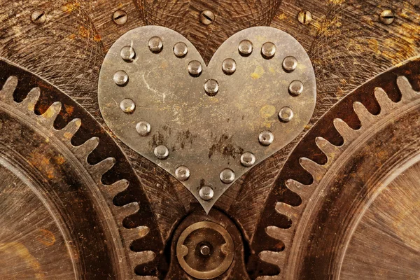 Grungy background with a metallic heart and rivets — Stock Photo, Image