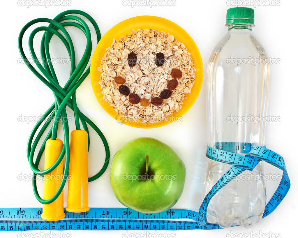 Bottle of water, muesli and green apple. Attributes of a healthy