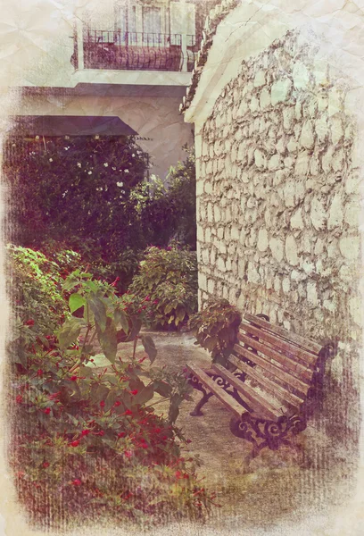 Bench near old stone wall — Stock Photo, Image