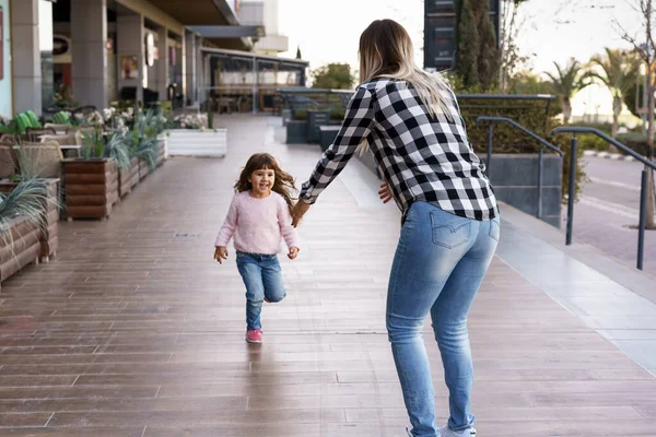 Cute little girl daughter running towards mothers embrace. — Stock Photo, Image