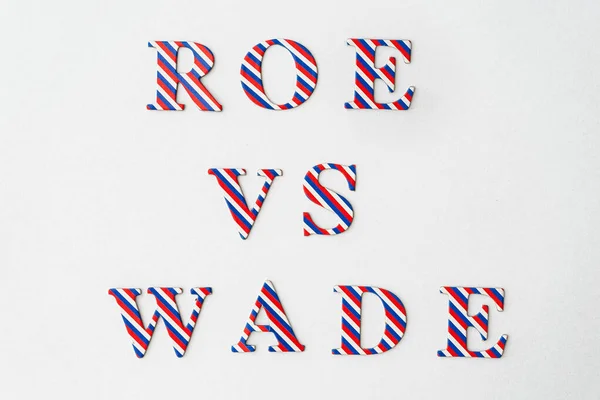 Roe VS Wade. Abortion process Roe versus Wade symbol. Concept words Roe vs Wade, a letters from American flag colors on white background.