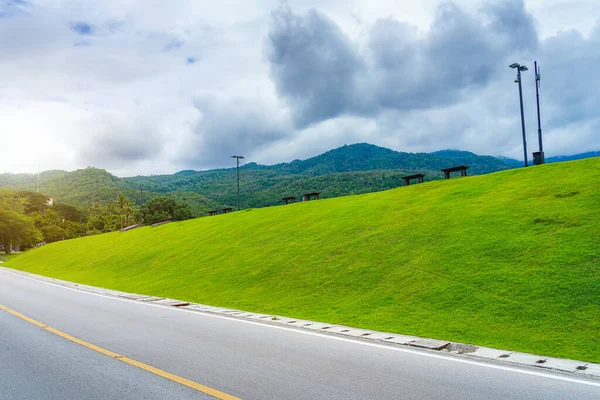 a public place leisure travel Asphalt black grey road landscape lake views at Ang Kaew Chiang Mai University in nature Doi Suthep forest Mountain views spring blue sky background with white cloud.