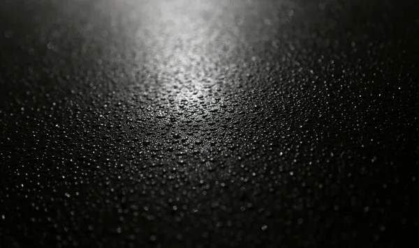 Капли воды на черный металл Стоковое Изображение