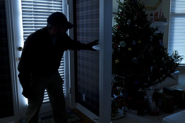 Burglar Breaking In To Home At Christmas Through Back Door — Stock Photo, Image