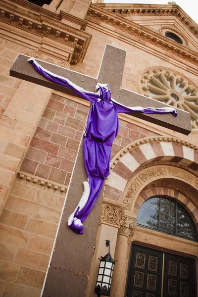 Wooden cross with Jesus in Purple Shroud cloth — Stock Photo, Image