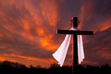 This dramatic sunrise lighting and Easter Cross makes a great Easter photo illustration of Jesus dying on the cross and rising again.