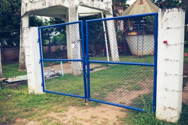 Blue Chain Link Fence Gate Locked with Key : Concept of Protecting Areas