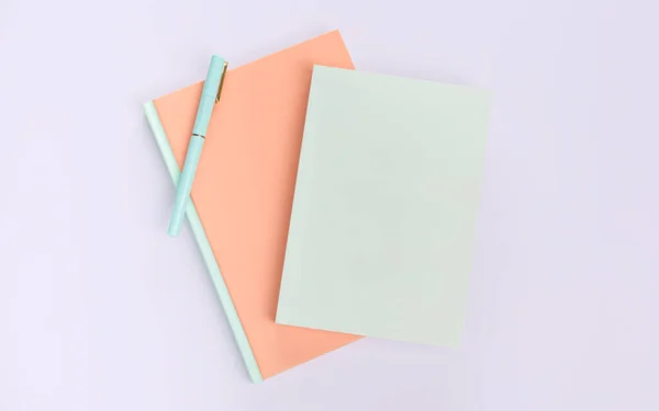flat lay book and stationery on purple background
