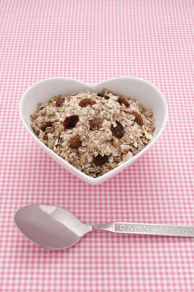 Muesli in a heart shaped bowl — Stock Photo, Image