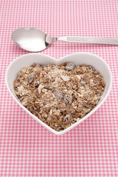 Muesli in a heart shaped bowl — Stock Photo, Image