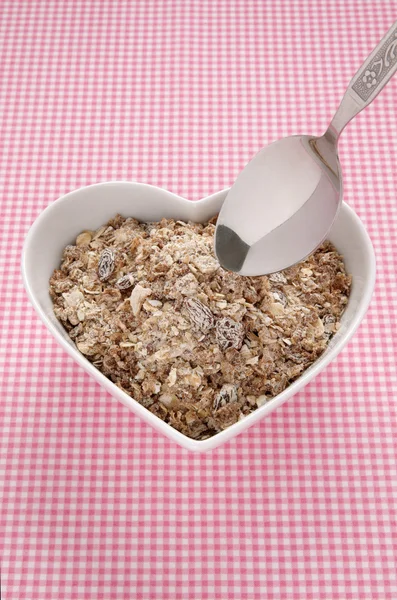 Muesli in a heart shaped bowl — Stock Photo, Image