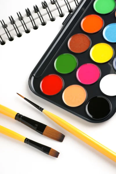 Paint brushes and sketch book — Stock Photo, Image