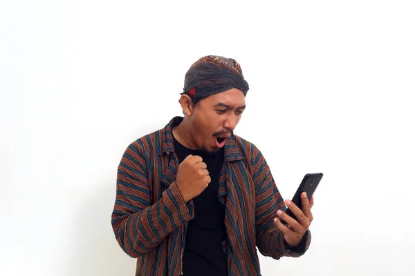 Überraschter Asiatischer Mann Javanischer Tracht Steht Der Hand Eines Mobiltelefons — Stockfoto