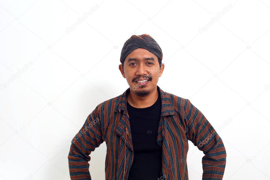 Asian man standing in Indonesian traditional costume over white