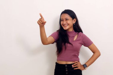 Asyalı kız gülümseyerek ayağa kalkar ve yanındaki boşluğu gösterir. Beyaz arkaplanda izole