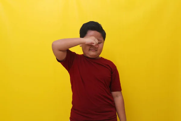 Sleepy Asian Boy Standing While Holding His Eyes Isolated Yellow — Φωτογραφία Αρχείου