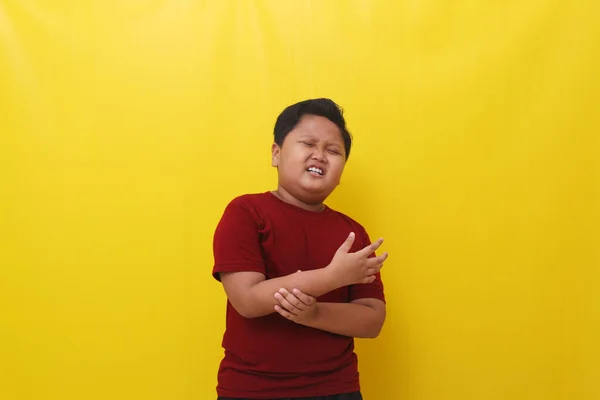 Asian Boy Feel Pain Arm Healthy Concept Isolated Yellow Background — Stockfoto