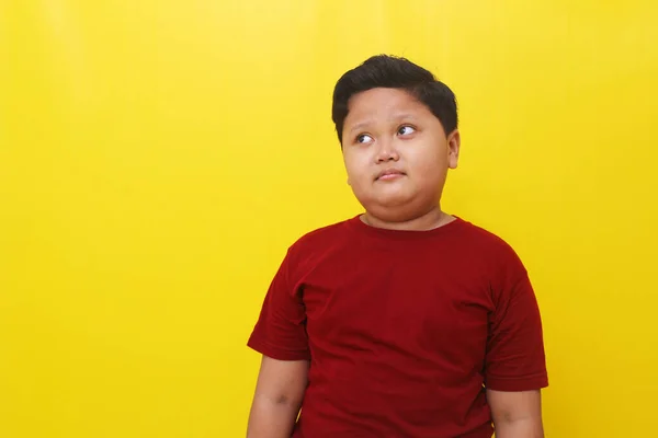 Thoughtful Asian Boy Standing While Imagine Something Isolated Yellow Background — Stok Foto