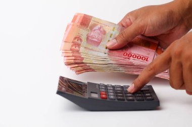 Banknotları tutarken hesap makinesi kullanmak. Kopyalama alanı ile beyaz arkaplanda izole