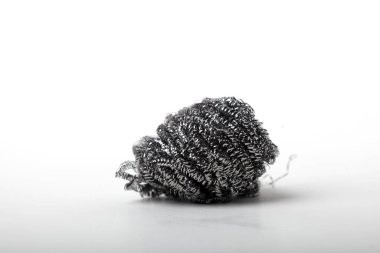 Metal sponge for cleaning and washing dishes on white background with copyspace