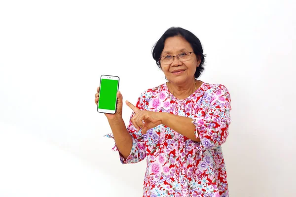 Happy Asian Elderly Woman Standing While Pointing Blank Cellular Phone —  Fotos de Stock