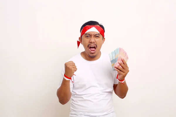 Excited Asian Man Standing While Holding Money Indonesian Independence Day — ストック写真