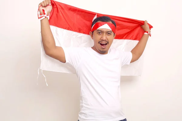 Passionate Asian Man Standing While Unfurl Flag Indonesian Independence Day — Stockfoto