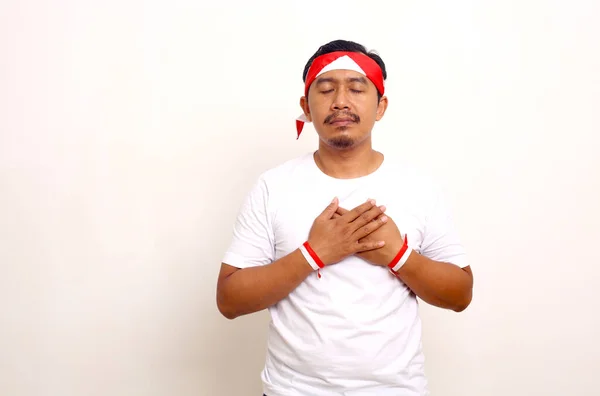 Relieved Asian Man Standing Hands Chest Indonesian Independence Day Concept — Stok Foto